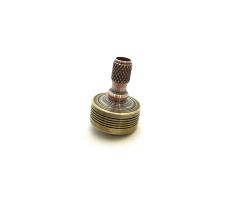 Machined brass and copper spinning top